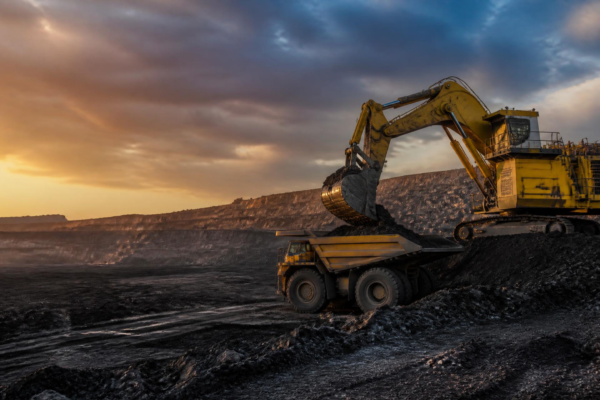 Excavator loading coal at an open-cast mining operation